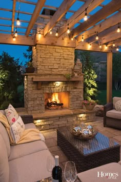 an outdoor living room with patio furniture and fire place