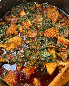 a pan filled with meat and vegetables covered in sauce