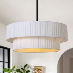 a white lamp hanging from the ceiling in a living room