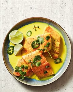 some food on a plate with limes and cilantro