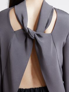 This elegant 2-ply silk crepe top has a looped tie at the back neck, framing an open back. Tuck this charcoal gray beauty into a high waisted skirt or pant for a more subtle look, or wear it loose and open! Made in New York City. 100% silk *Made to order. Please allow 2 weeks for production. MEASUREMENTS Small: Shoulder : 14" / Bust: 34-35" / Sleeve Bicep: 12" Medium: Shoulder: 14.5" / Bust: 35-37" / Sleeve Bicep: 13" Large: Shoulder: 15" / Bust: 38-41" / Sleeve Bicep: 14" Need help? Contact us