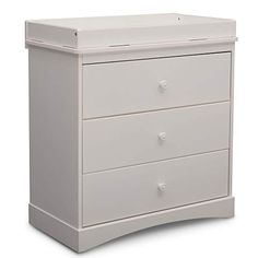 a white baby crib with three drawers