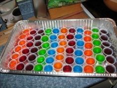 a pan filled with lots of different colored cups