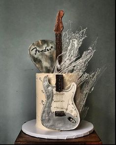 a birthday cake with an electric guitar on top and the name fender written on it