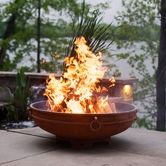 a fire pit sitting on top of a cement slab