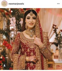 a woman in a red and gold bridal outfit