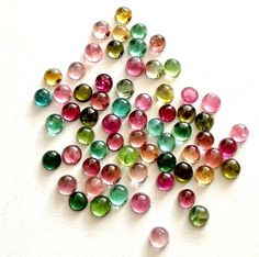 many different colored stones on a white surface with the words gems daily written below them