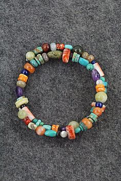 This beaded turquoise, coral, lapis, amber, spiny oyster, mother of pearl, abalone, jasper, onyx and amethyst stretchy wrap bracelet was expertly crafted by Navajo artisan Helen Tsosie.Circumference: 5 1/2" (adjustable)Width: 1/2"Free shipping on all orders! We ship with USPS and always include tracking. All orders ship within a day of payment.Returns are accepted up to 30 days after you receive your order. Just send us a message. Our shop offers cash back or store credit. The item must be returned in new condition. Multicolor Natural Stone Beaded Bracelets For Festivals, Multicolor Multi-stone Bead Bracelets, Multicolor Bohemian Stretch Bracelet Hand-strung, Multicolor Multi-stone Beaded Bracelets, Multicolor Bohemian Stretch Bracelet For Healing, Multicolor Hippie Bracelets, Bohemian Style Multicolor Hand-strung Stretch Bracelet, Bohemian Stretch Bracelet With Spacer Beads For Healing, Adjustable Multi-stone Round Bead Bracelets