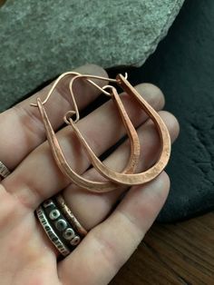 This style hoop earrings are a classic design and perfect for everyday wear. Each pair is forged by hand from recycled copper and have a celtic / modern viking style. Choose from rustic (last photo) or raw copper finish.  Hoops are made to order just for you! Copper is the traditional gift for the 7th anniversary. MEASUREMENTS & SPECIFICS:Shown in rustic copper and raw brass.  SIZE: approximately 5 x 4 cm (custom sizes available convo before ordering)EARWIRE: choose from copper or Sterling s Everyday Hand Forged Bronze Earrings, Artisan Hand Forged Earrings For Everyday, Rustic Everyday Earrings, Artisan Hoop Earrings With Ear Wire For Everyday, Artisan Hand-forged Earrings For Everyday Wear, Everyday Hand Forged Teardrop Hoop Earrings, Minimalist Copper Earrings For Everyday, Copper Hammered Hoop Earrings As Gift, Minimalist Hammered Copper Jewelry