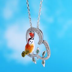 Designed for the free-spirited, the kingfisher is symbolic of freedom, courage, adventure, and balance. Each piece has been delicately hand-painted, displaying the uniqueness of its bright yellow feathers and orange plumage against a silver base. It is a true gift to spot one of these elusive creatures in nature.Carat Weight: 0.341 ctStone Size: 1,3*3,0.8 mmStone Type: Jeulia® StoneNumber of Stones: 44 Stone Shape: Round, HeartStone Color: Diamond White, Garnet RedChain Type: Cable chainWeight: Green Bird Design Jewelry Gift, Green Jewelry With Bird Design As Gift, Green Jewelry With Bird Design For Gift, Whimsical Bird Design Jewelry For Gifts, Unique Bird Design Pendant Jewelry, Whimsical Bird Design Jewelry For Gift, Bird Design Enamel Jewelry Gift, Enamel Jewelry With Bird Design For Gifts, Free As A Bird