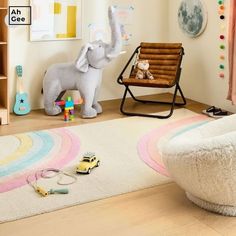 a child's room with an elephant rug and toy cars