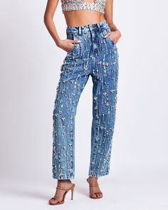 This slouchy straight jean features rhinestone-encrusted beadwork that is sewn entirely by hand. Oversized, 90’s-era fit with a high-waisted fit. Rigid denim with minimal stretch. This is a couture piece that is made entirely by hand. Zip front closure. Made in Brazil. 100% COTTON. CAL26990US. Jeans With Sequins, Denim Eras Tour Outfit, Denim Couture Fashion, Bedazzled Jeans Outfits, Denim Rhinestone Outfit, Diy Bedazzled Jeans, Denim And Rhinestone Outfit, Rhinestone Jeans Outfit, Denim And Diamonds Outfit