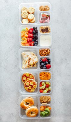 a plastic container filled with lots of different types of food and snacks on top of it