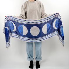 The moon shows all its faces in "Phases". Shades of blotted blue punctuate every corner of the night sky. Stare wistfully at the stars bundled up in this versatile scarf.   Inspiration: Learning About Our World, 1932 - Soft cotton blend - Fan favorite 72" x 18" size - Versatile styling options - Timeless book-inspired design - Perfect for all-season wear Scarf Inspiration, Blue Accessories, Whimsical Fashion, Wedding Board, Hope Chest, Moon Phases, Book Lovers Gifts, Bandanas, Night Sky