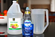 a bottle of water and a container of liquid on a table