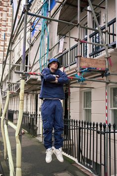 a man is hanging upside down on a scaffold