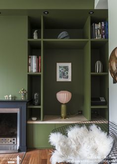 a living room with bookshelves and a fireplace