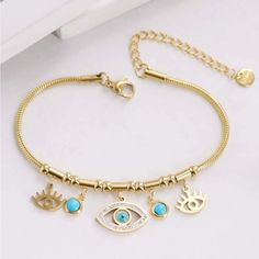 Gorgeous Turquoise Eye Charm Bracelet Drop Crystal Blue Evil Eye In The Middle Rhinestone Detailing Two Turquoise Beads On The Side And Two More Gold Evil Eyes Gold Chain So Gorgeous And Chic New - Perfect Condition Dimensions In Last Photo Trendy Gorjana White Gold Silver Metallic 14k Adinas Jewels Swarovski Eye Yellow Gold Black Pupil Diamond Accented Baublebar Mejuri 14k Link Gorjana Alex And Ani Hands Cz Shashi Mejuri Coach Mezzo Stone Ana Luisa Apm Monaco Kate Spade Lime Neon Y2k Blue Purpl Neon Y2k, Adinas Jewels, Pink Art Deco, Rare Diamond, Turquoise Eyes, Apm Monaco, Evil Eyes, Gold Bracelet For Women, Crystal Blue