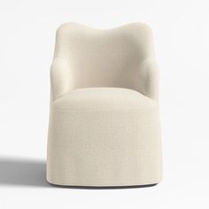 an upholstered white chair on a white background with no one in the room