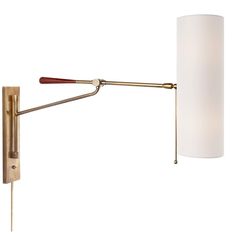 a wall light with a white shade on the side and a wooden handle attached to it