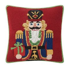 a red pillow with a nutcracker on it