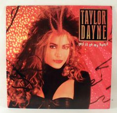 the album cover for taylor dayne tell it to my heart is shown on a wooden surface