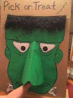 a cardboard cut out of the face of a green monster