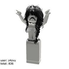 a white and black doll with long hair on top of a pedestal in front of a white background