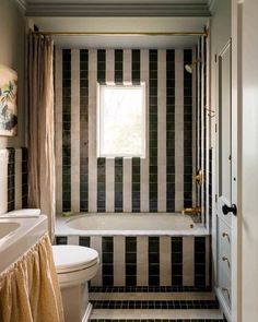 a bath room with a toilet a tub and a sink