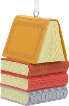 a stack of books ornament hanging from a string