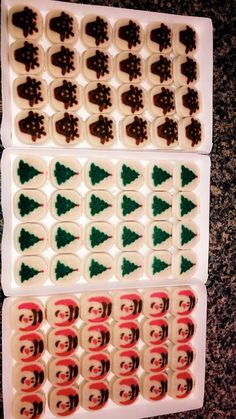 two trays filled with different types of christmas cookies on top of a table next to each other