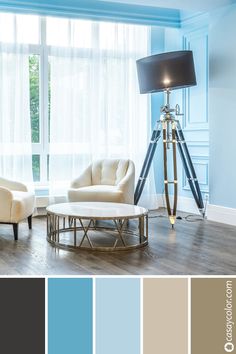 a living room with blue walls and white furniture in the center, along with neutral colors