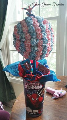 a spiderman pinata in a cup on a table