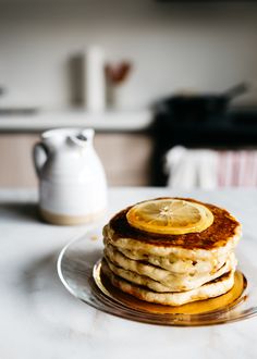 a stack of pancakes sitting on top of a glass plate