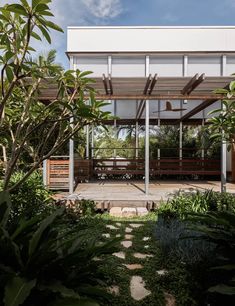 the house is surrounded by greenery and trees