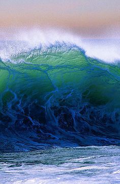 a large wave is breaking over the ocean