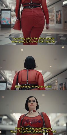 a woman in red is walking through an airport with her back turned to the camera