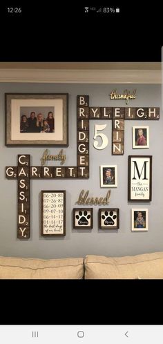 a living room wall decorated with family pictures