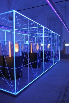 a room that has some kind of structure on the floor with lights in it and blue lighting