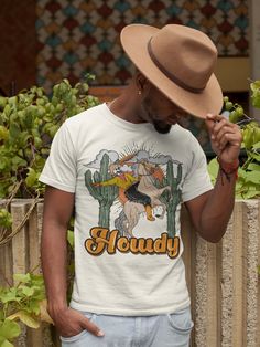 "HOWDY SKELETON (UNISEX TEE): Designed and handmade in Phoenix. Yeeeehawwww. A twist on our original, featuring our cowboy skeleton. This tee is perfect for to match with your cool little dude or dudette. Perfect for a Rodeo pregnancy announcement, Rodeo western birthday, cowboy shirt, or just general cool Wild West vibe. Unisex Tee: XS - 3XL Runs a little bit large. Order down for a more snug fit, or order normally for a longer and more relaxed tee. This tee style is super popular because it dr Cowboy Skeleton, Skeleton Cowboy, Howdy Shirt, Wild West Cowboys, Western Birthday, Western Style Shirt, Rodeo Shirts, Cowboy Shirt, Cowboys Shirt