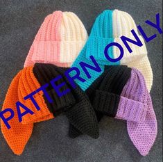 four crocheted hats with the words pattern only written in blue, pink, orange and black