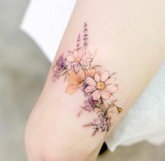 a woman's foot with flowers on it