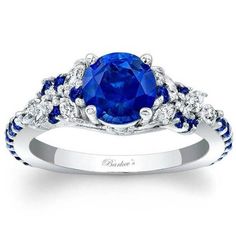 a blue sapphire and diamond ring with white diamonds on the band, set in 18k white gold