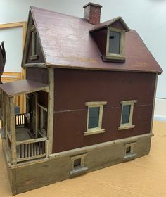 a doll house with an elephant statue next to it