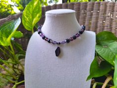 A witchy and whimsical bohemian glass choker necklace. Crafted with various shades of purple Czech glass beading, faceted black Czech glass beading, painted black wood beading, and a striking diamond-shaped black ceramic pendant at the center. *Handmade by me, one of a kind. *Hypoallergenic stainless steel chain and clasp.  Nickel Free. *Total Length: 14.5 inches *Length of Chain: 13 inches *Extender Length: 1 inch. If you require a longer extension chain to ensure a proper fit, please let me know!  Just let me know how long you would like your necklace under personalization instructions. (free of charge) *Width & Length of Ceramic Pendant: 11 mm x 20 mm *Clasp and Chain Material: Lobster claw and jump rings made of stainless steel.  *Strung on strong and flexible 23-strand stainless steel Adjustable Black Witchy Necklace, Black Adjustable Gothic Necklace, Handmade Black Witchy Necklace, Bohemian Purple Glass Necklace, Gothic Black Beaded Necklace, Grunge Necklace, Bohemian Grunge, Punk Necklace, Witchy Halloween