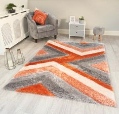 an orange and grey area rug in a living room