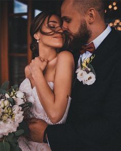 a bride and groom are embracing each other