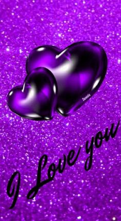 two purple hearts with the words i love you written on it in front of some glitter