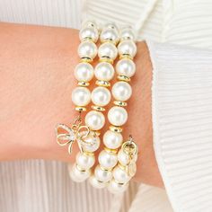 Our exquisite White Pearl Wrap Bracelet is an absolute must for an ultra-feminine wristscape™. Three turns of luxurious pearls are highlighted with tiny gold rondelles and finished with a precious bow charm in gold with clear crystals. Alone BuDhaGirl’s White Pearl Wrap Bracelet is sophisticated and classic, and paired with White Pearl Three Queens All Weather Bangles® makes for a mesmerizing combination! Throughout history, pearls have captivated women from every corner of the globe. Their enchanting allure extends beyond their ethereal beauty to the rich stories they embody. Pearls are a symbol of purity, wisdom, and inner beauty, encapsulating the essence of femininity and grace. Handcrafted in the US. One size. Bow Charm, Photography Lenses, Cami Maxi Dress, Bangles Making, Ultra Feminine, Pink Moon, Vintage Couture, Capri Blue, Clear Crystals