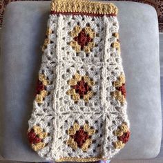 a crocheted blanket sitting on top of a couch